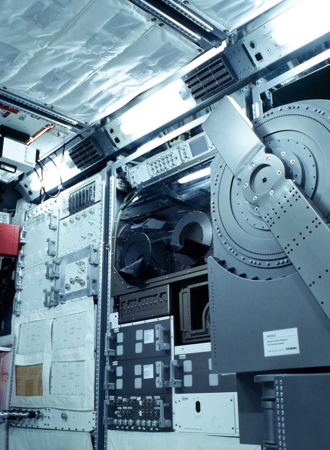 A complex array of scientific equipment and panels fills the interior of a spacecraft.