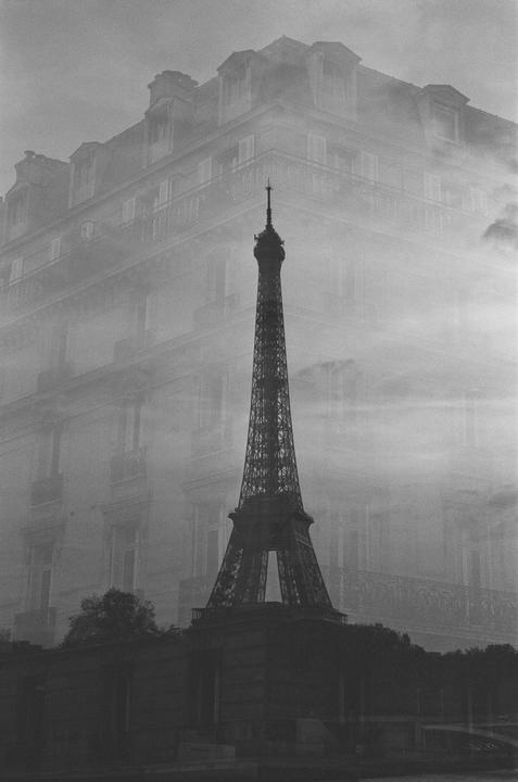 A double exposure shows the Eiffel Tower superimposed over a building in Paris.