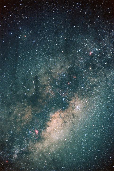The Milky Way is visible in the night sky, with many stars and some nebulae.