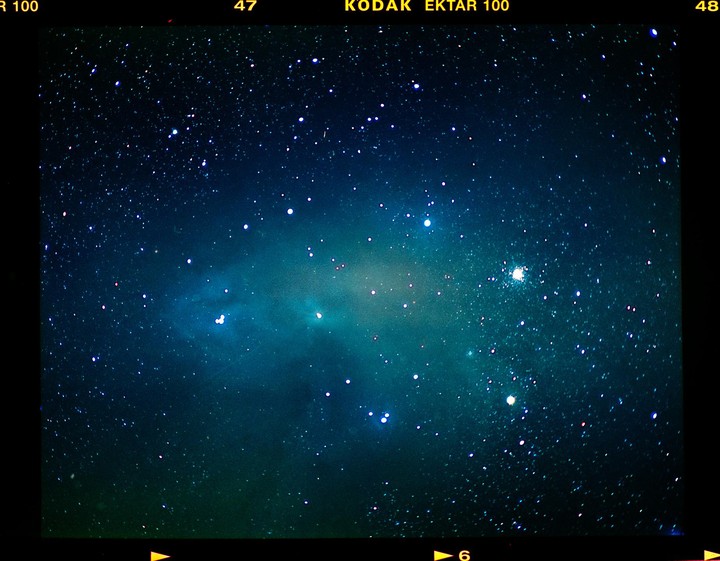 A cosmic space cloud is visible among many stars in the night sky.