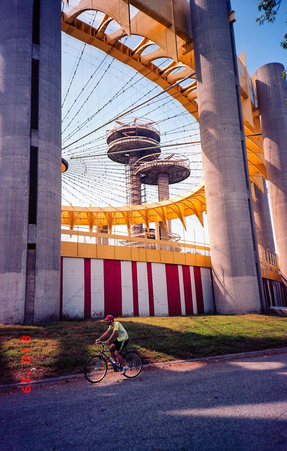 A man rides a bicycle past the New York State Pavilion in Flushing Meadows Corona Park.