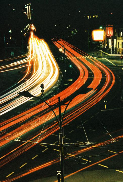 Light trails from vehicles illuminate a multi-lane road at night in Bucharest, Romania.