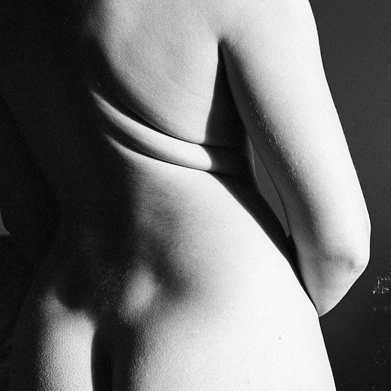 The back and arm of a person are visible in black and white.