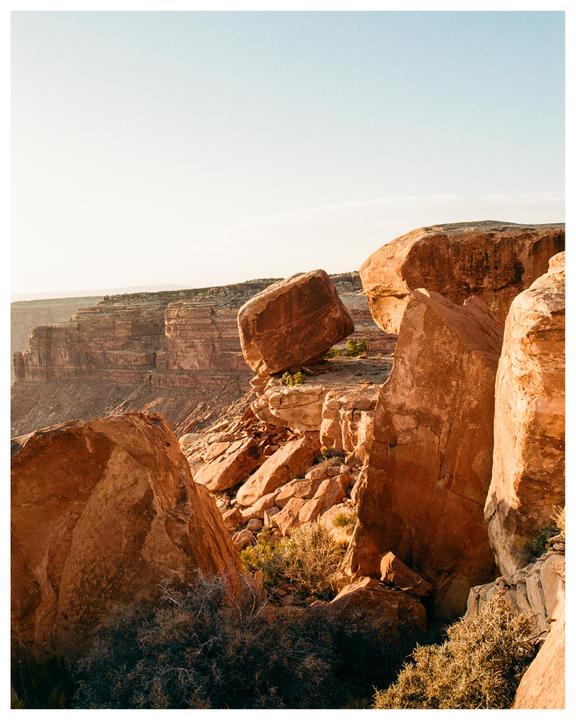 Large red rock formations and cliffs are visible under a clear sky.