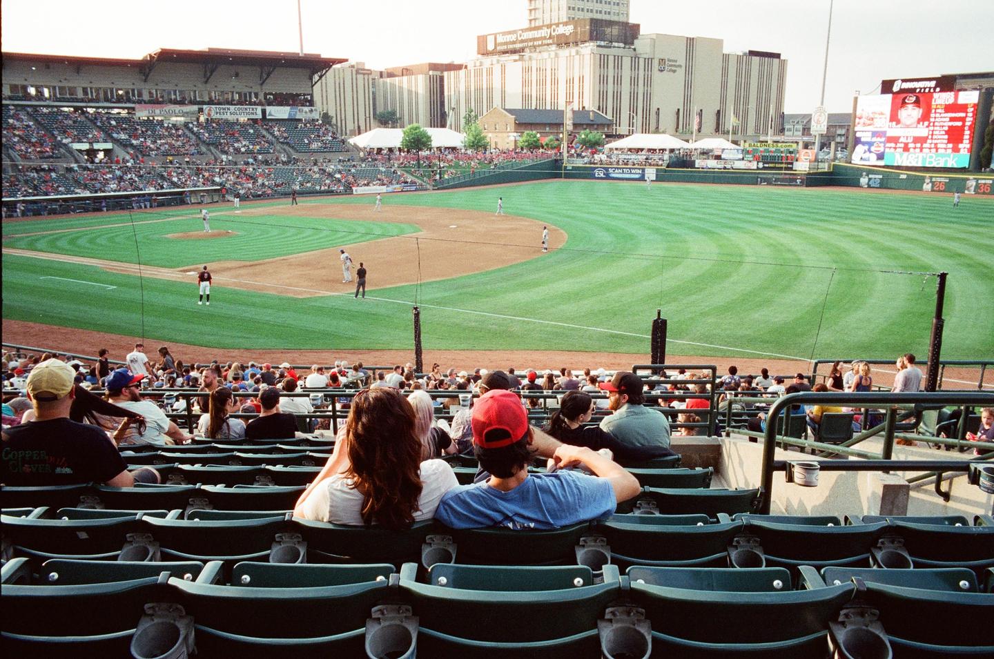 A baseball game is in progress at a stadium with many spectators in the stands.
