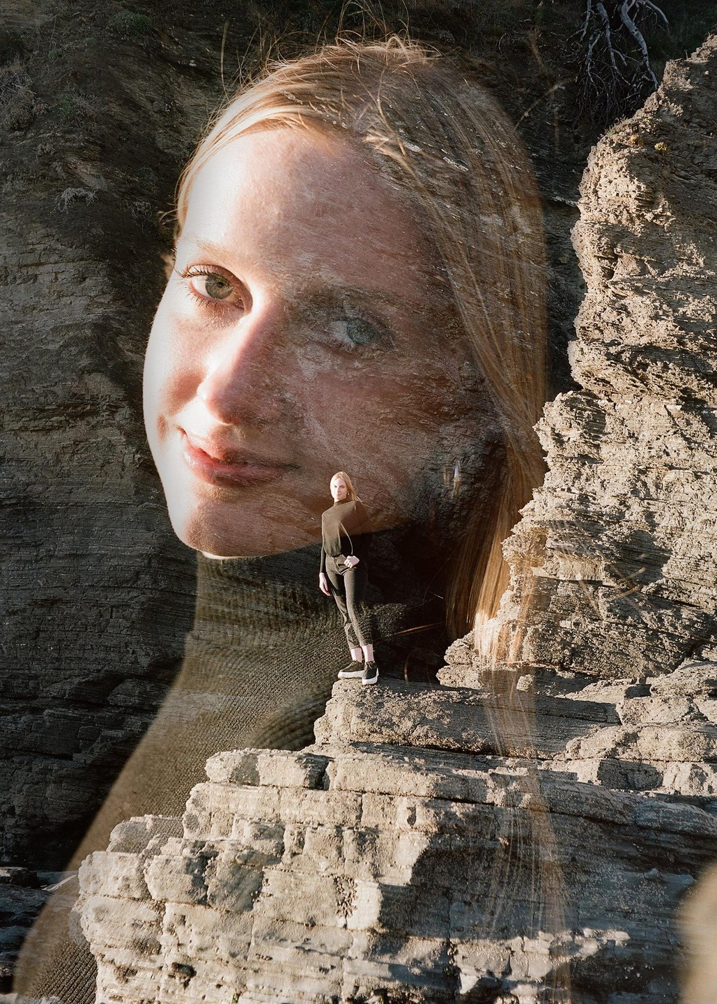 A double exposure shows a woman standing on a rocky cliff, superimposed with a close-up of her face.