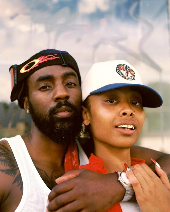 A man and a woman are posing for a close-up portrait.