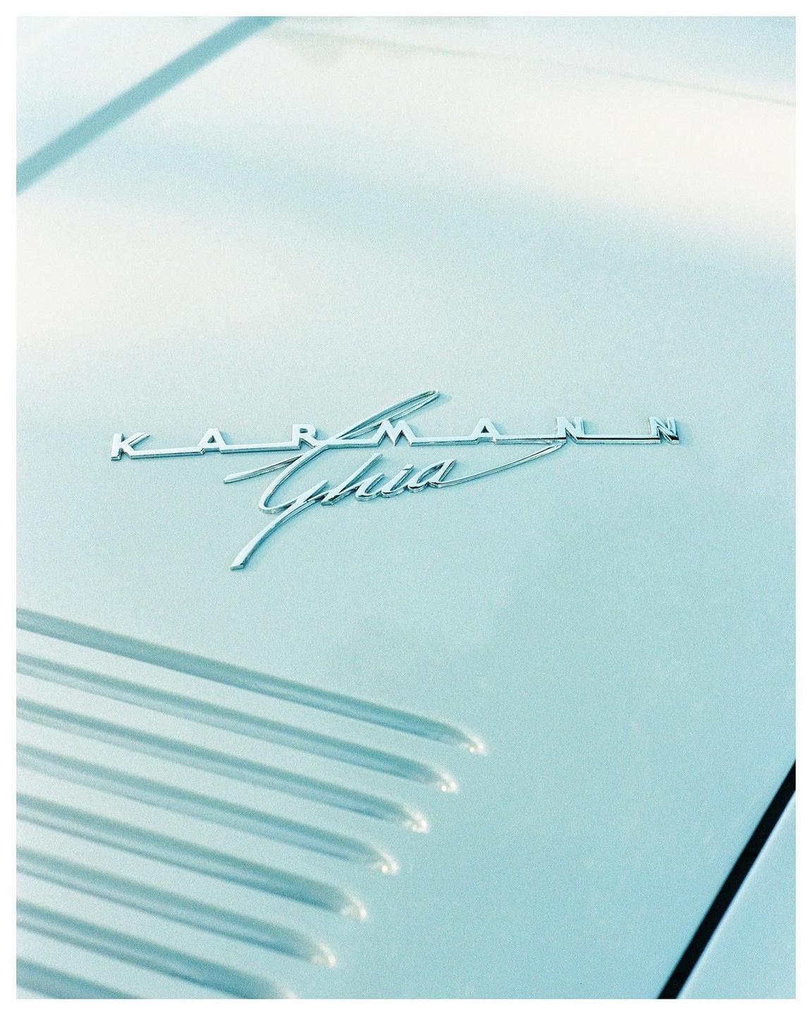 The "Karmann Ghia" emblem is visible on the hood of a light blue car.