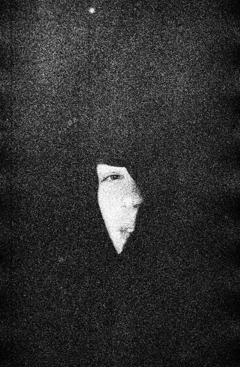 A woman's face is partially visible in a high-grain, black and white portrait.