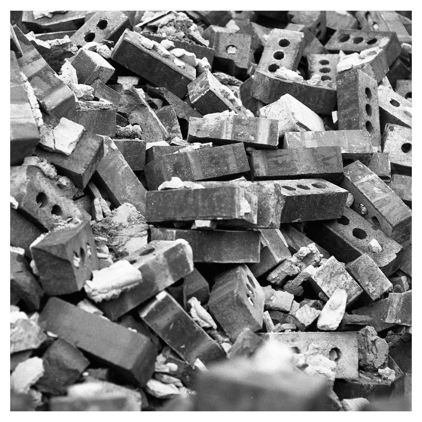 A pile of broken bricks is shown in black and white.