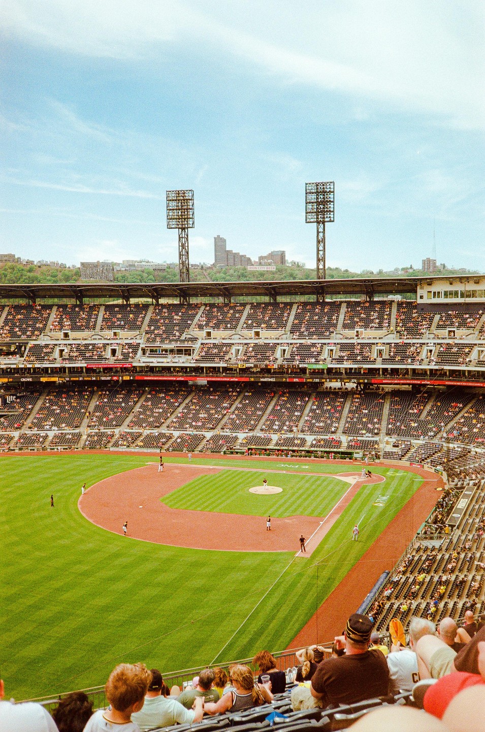 A baseball game is in progress at a stadium with many spectators in the stands.