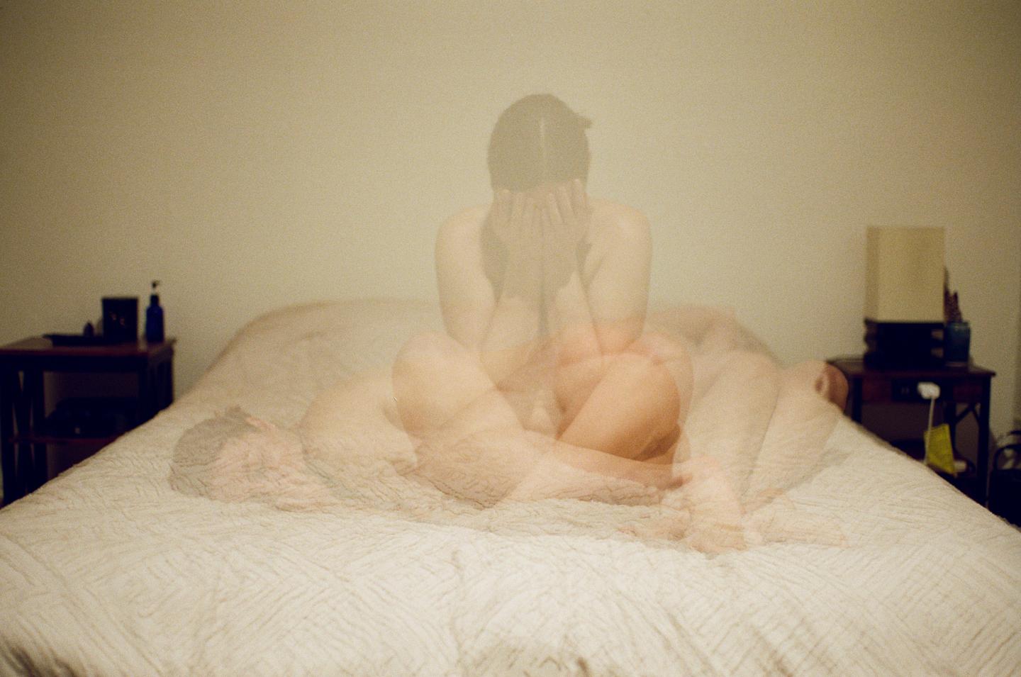 A double exposure self-portrait shows a person sitting on a bed with their face in their hands, and another person lying down on the bed.