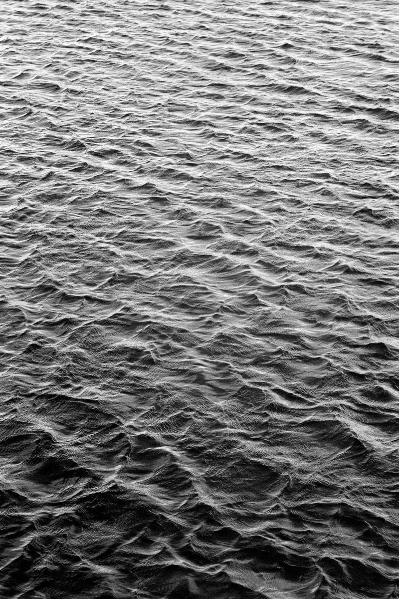 The surface of water is covered in small, choppy waves.