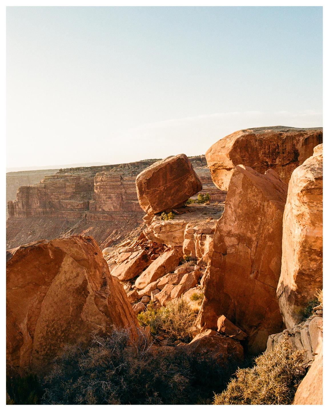 Large red rock formations and cliffs are visible under a clear sky.