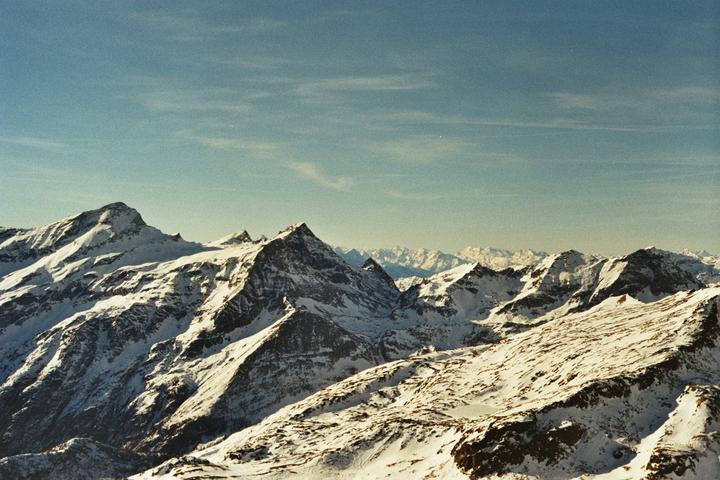Snow-covered mountains are visible under a clear sky.