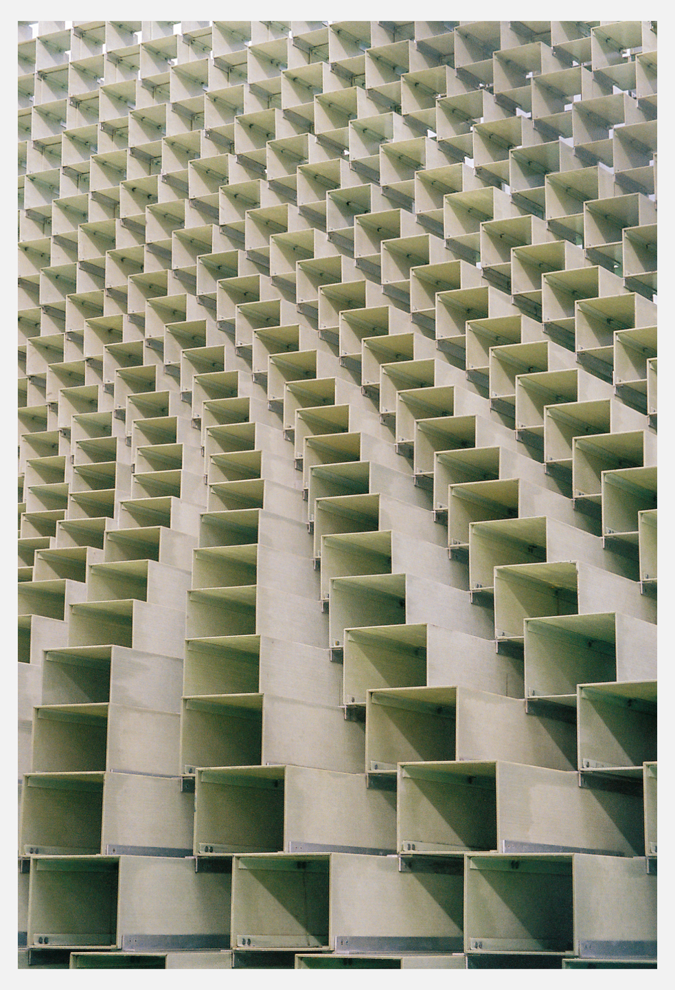 A wall of square, box-like structures creates a repeating pattern.
