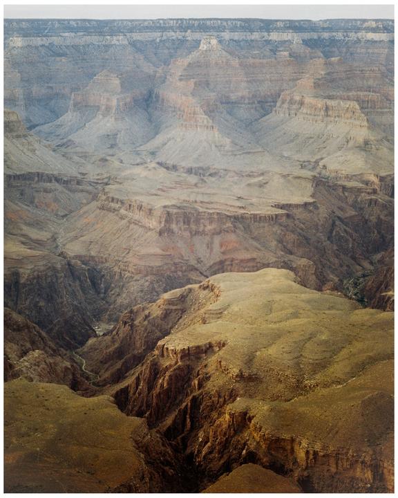 A vast canyon stretches into the distance with multiple layers of rock formations.