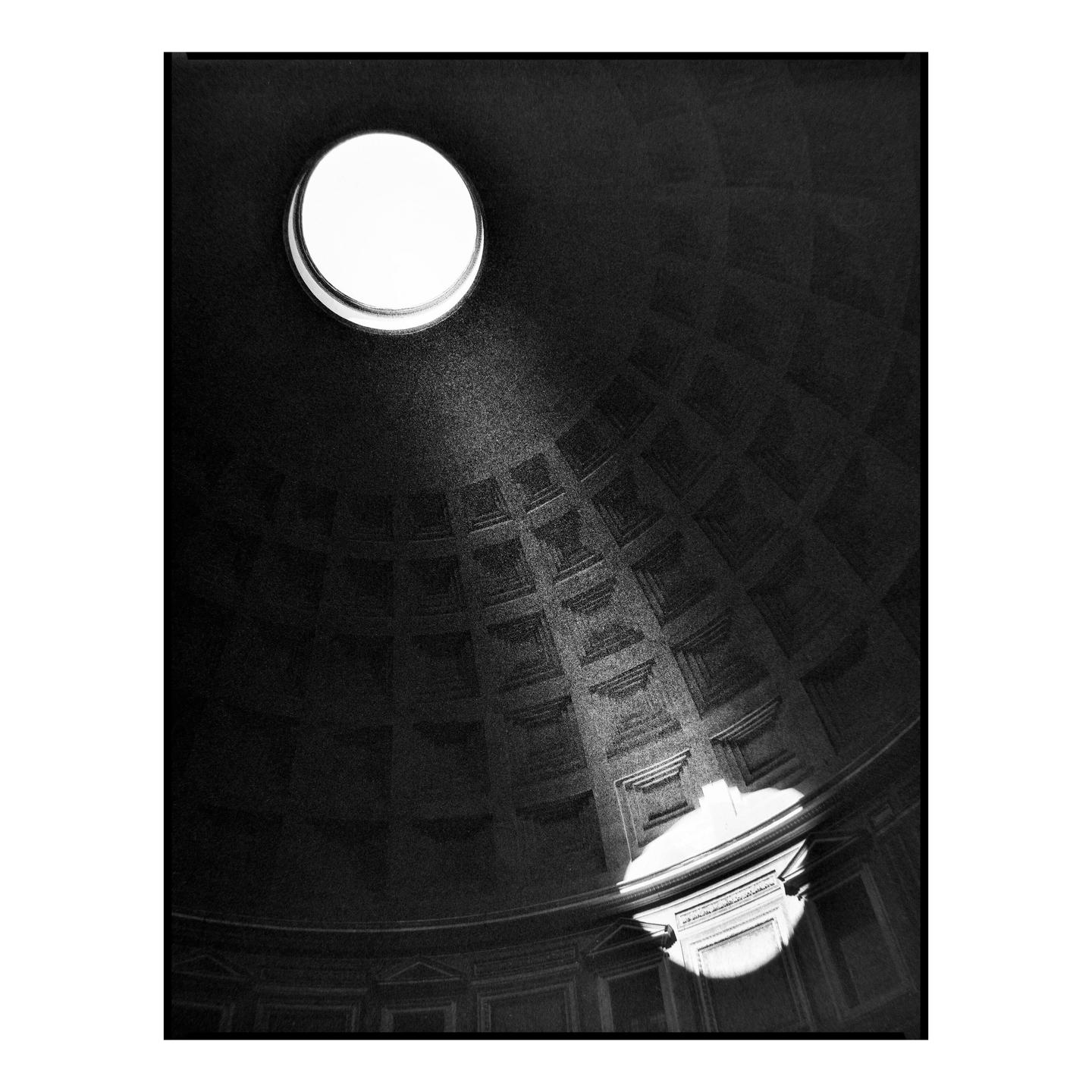 Light streams through the oculus of a large domed ceiling, illuminating a section of the coffered interior.