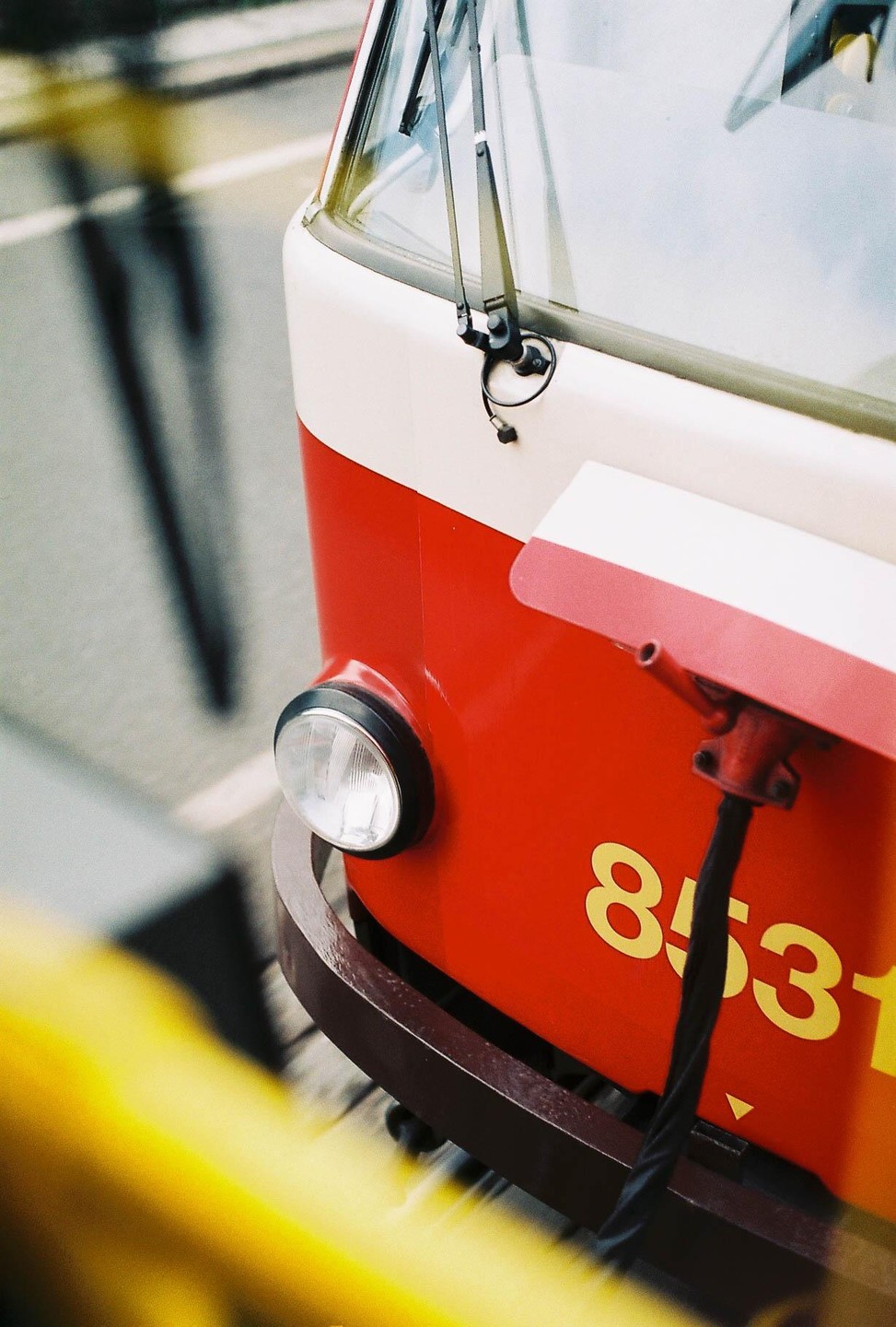 The front of a red and white tram with the number 8531 is visible from an elevated perspective.