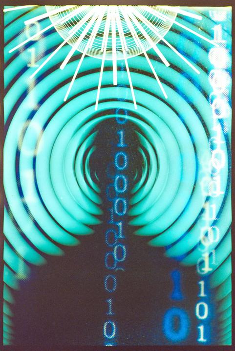 A multiple exposure shows binary code and radiating lines over a background of concentric circles.