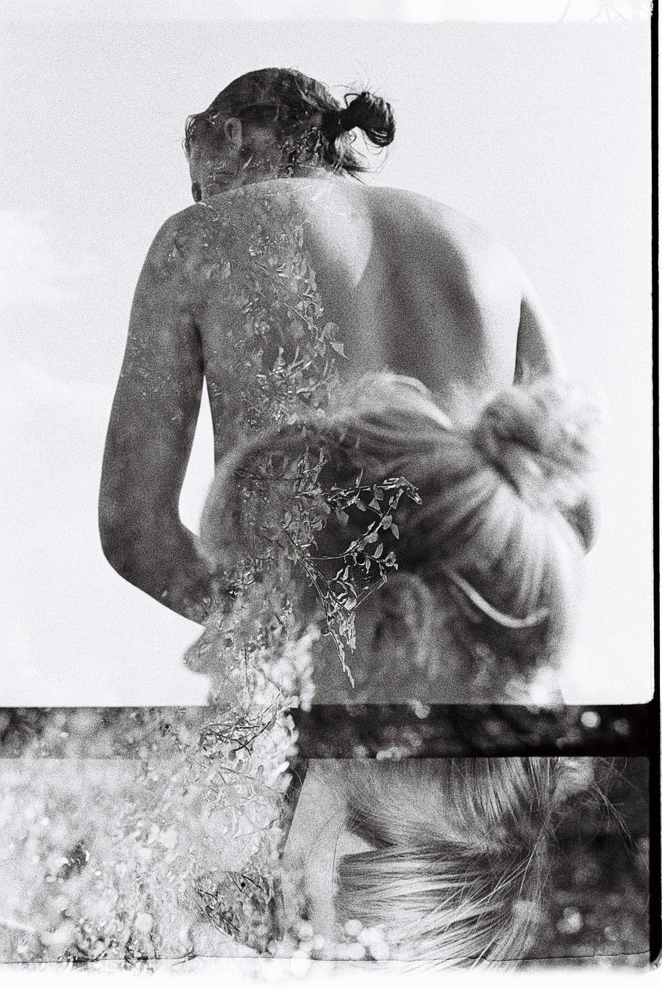 A double exposure shows a woman's back overlaid with foliage, and a second woman's hair in the lower part of the frame.