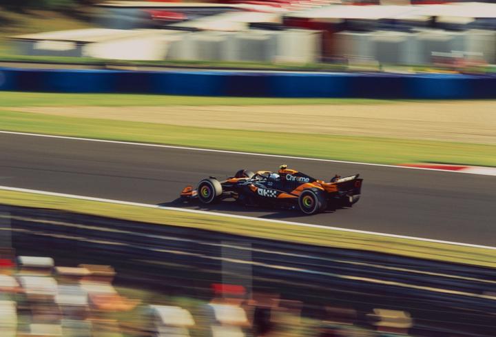 A McLaren Formula 1 car speeds around a track during the Hungarian Grand Prix.