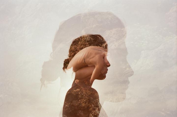 A triple exposure shows a woman's profile with a hand covering her face and a landscape superimposed over her body.