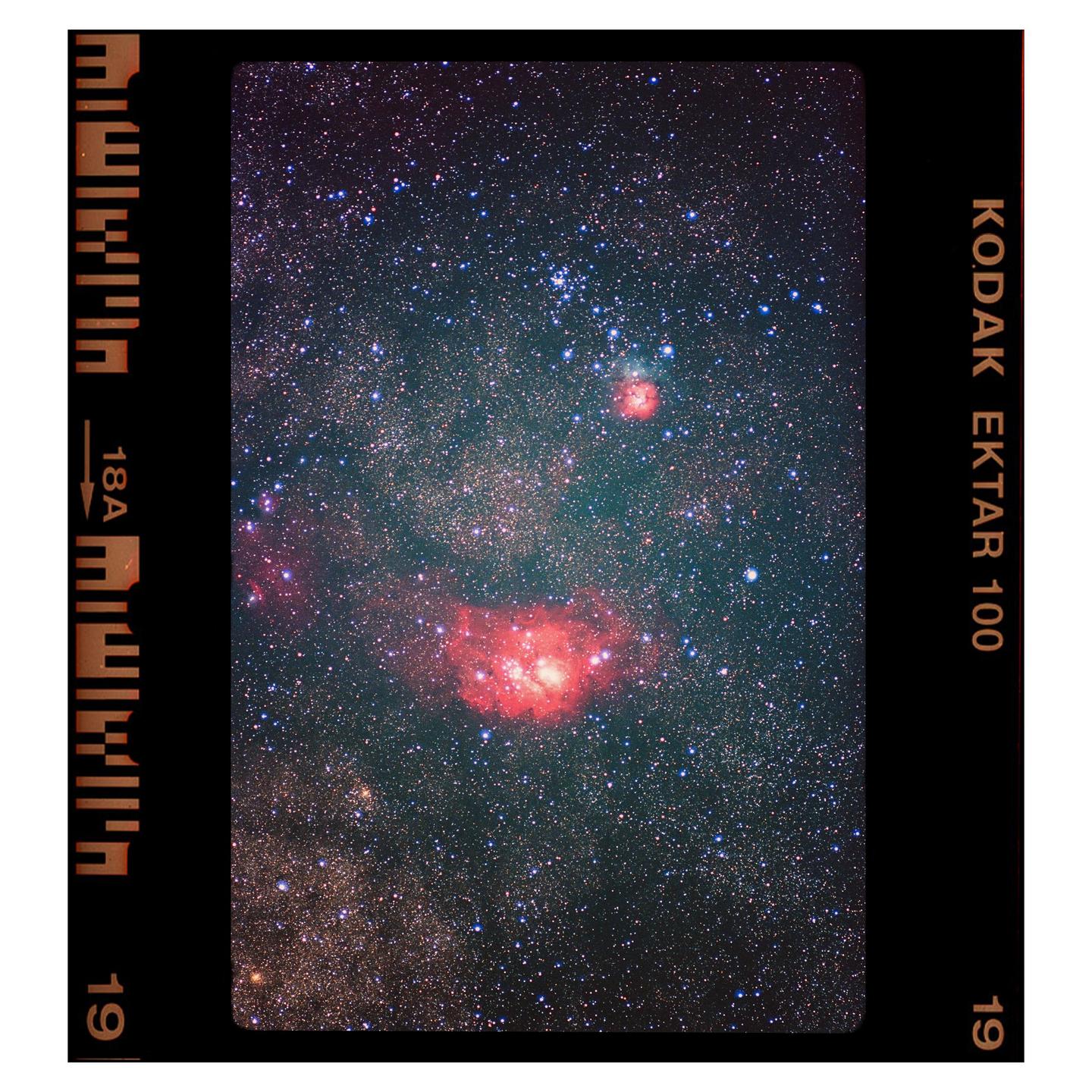 A long exposure photograph captures the Lagoon Nebula and surrounding stars.