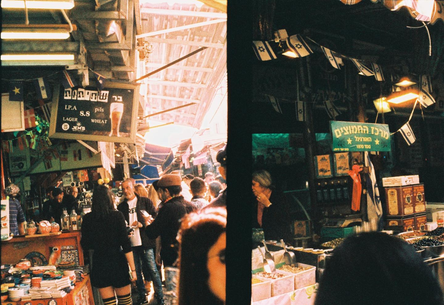A split image shows a busy market on the left and a woman at a stall with Israeli flags on the right.
