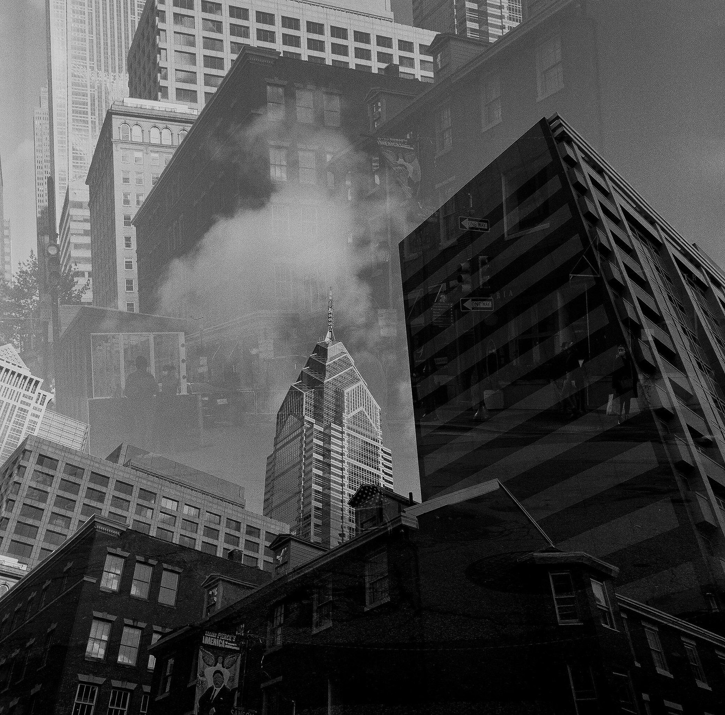 A double exposure shows multiple buildings, including One Liberty Place, with steam rising in the middle ground.