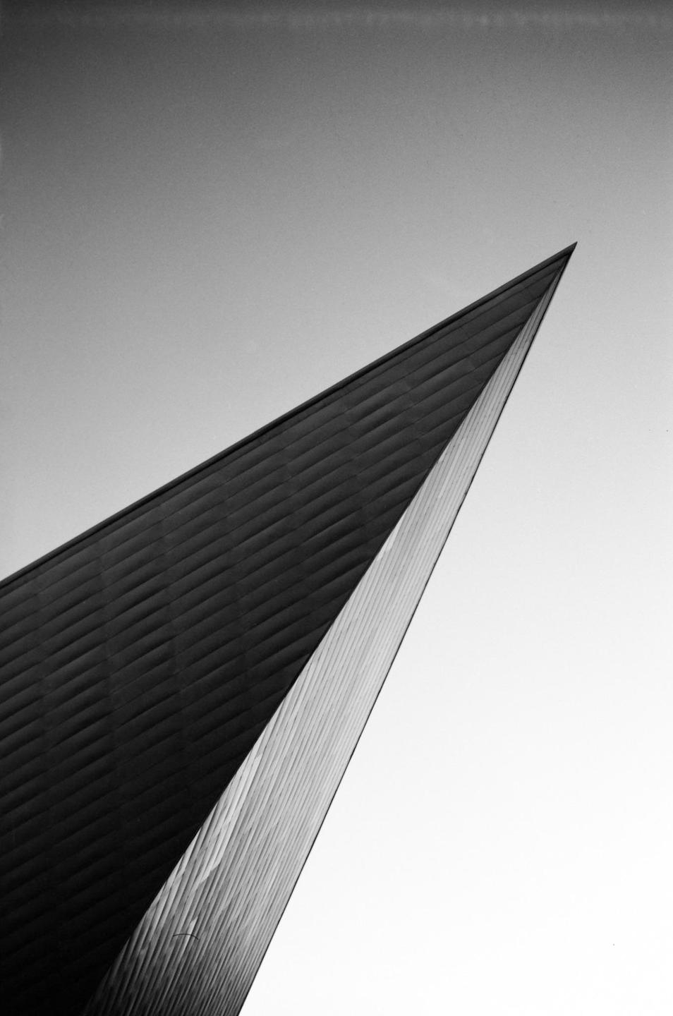A sharp, angular building facade points towards the sky.