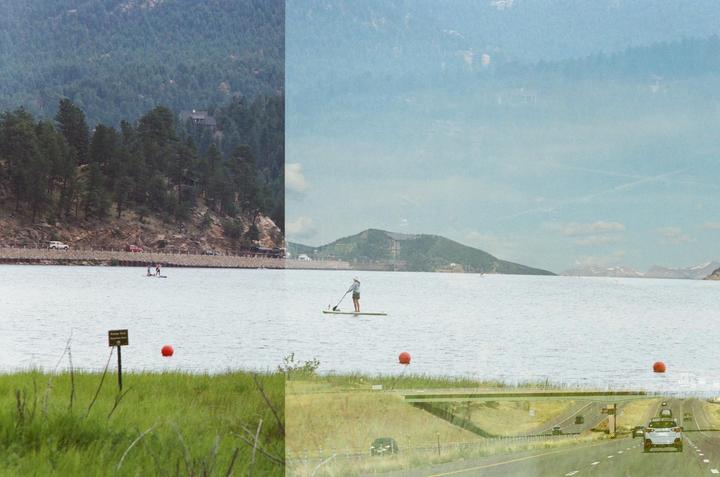 A double exposure shows a lake with paddleboarders and a highway with cars, set against a backdrop of mountains and trees.
