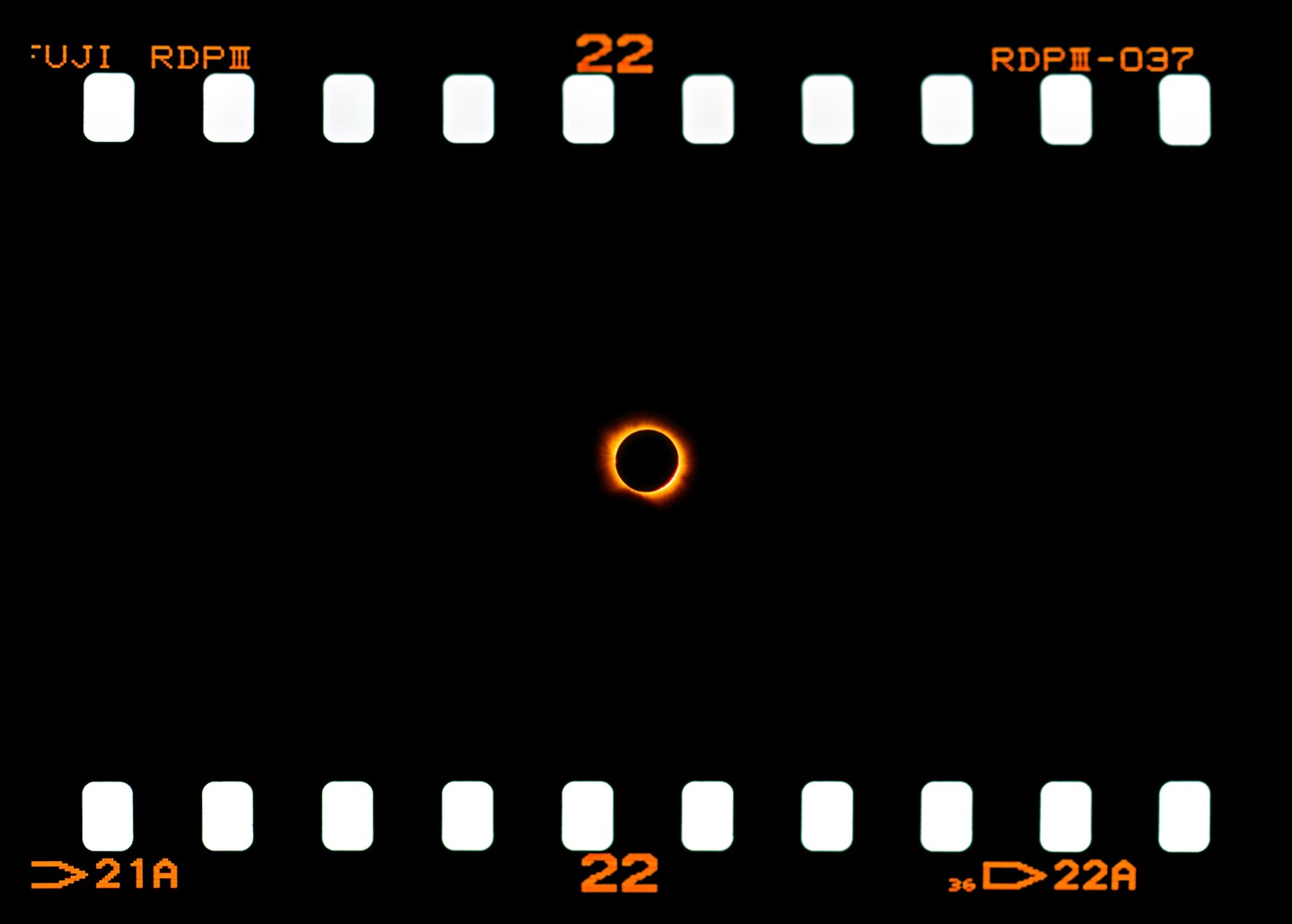 A solar eclipse is visible on a strip of film.