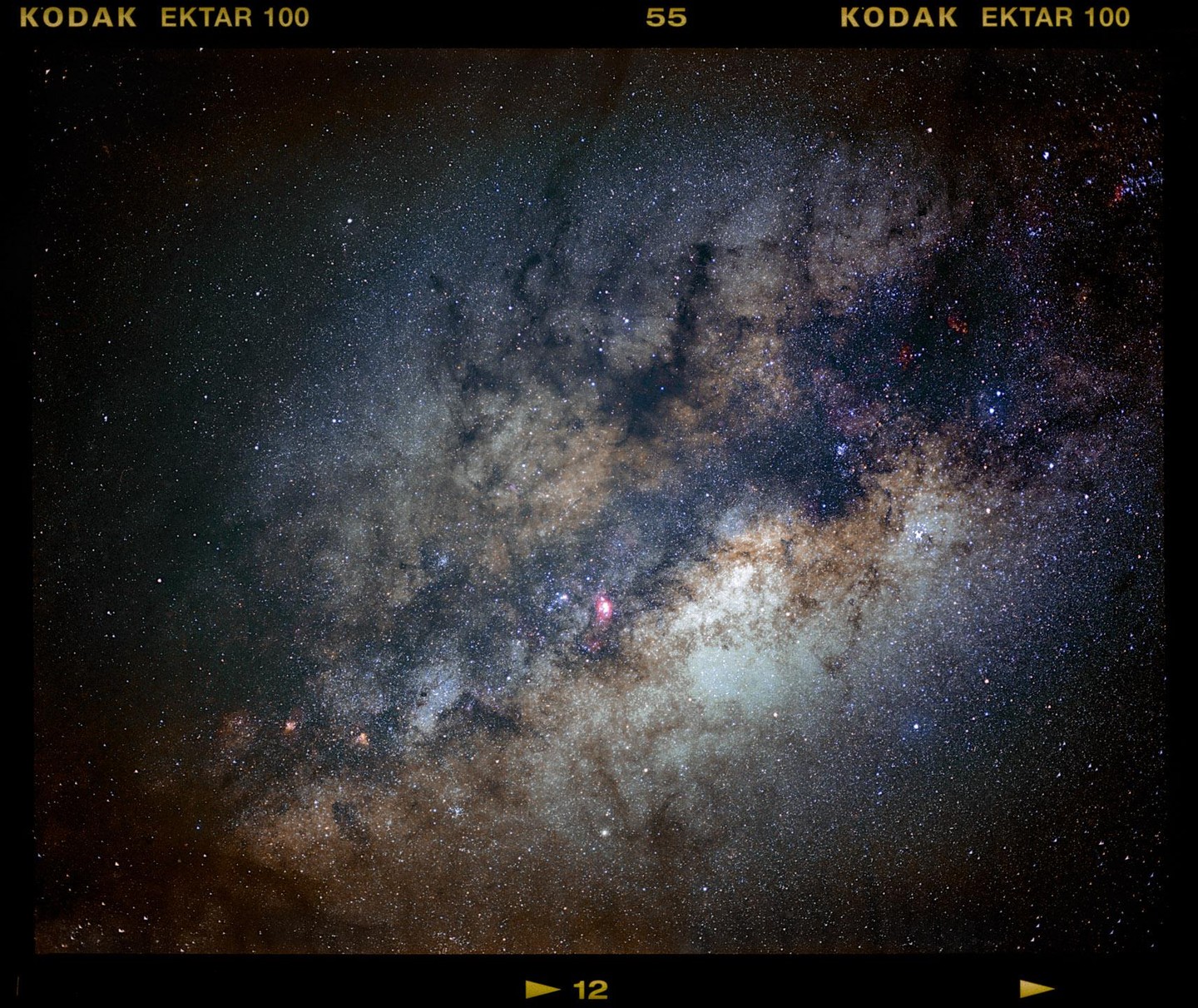 The galactic center of the Milky Way is visible with many stars and nebulae.