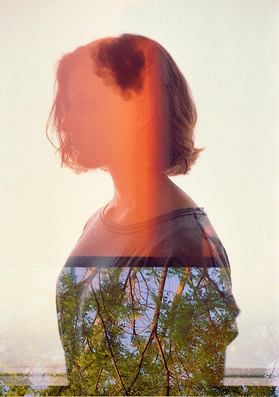 A double exposure shows the silhouette of a woman overlaid with a forest.