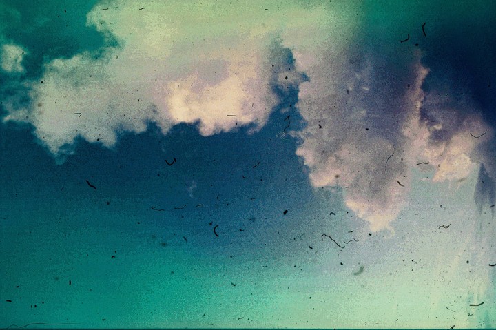 Clouds fill the sky, which transitions from dark blue to light blue.