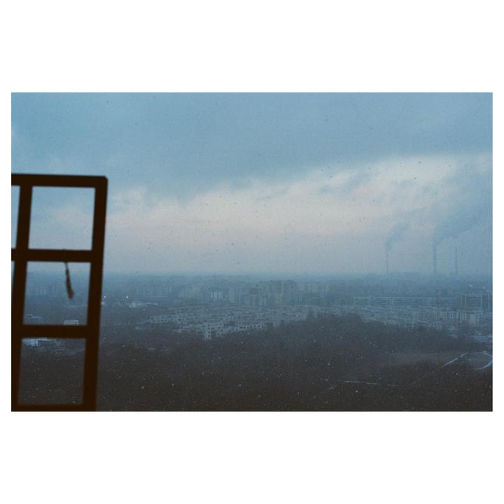 A city skyline is visible through a window on a hazy winter day.
