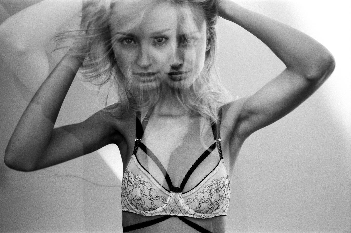 A woman with blonde hair and a bra is shown in a double exposure.