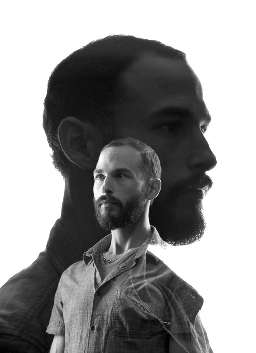 A man with a beard is shown in a double exposure, with one profile view and one frontal view.