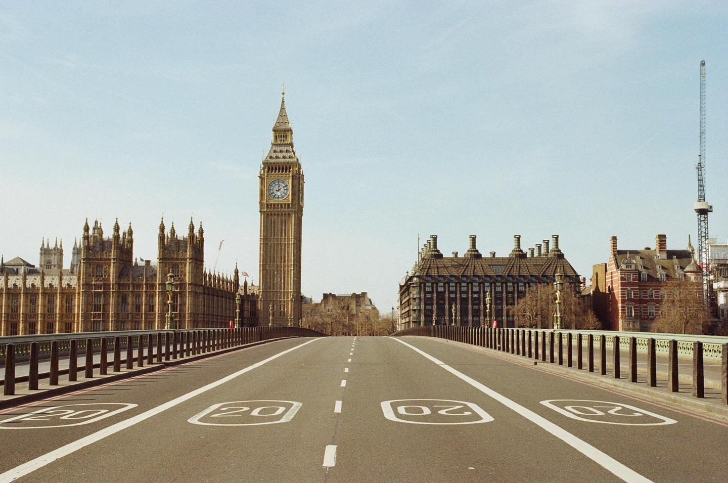 A wide shot of an empty Westminster Bridge with Big Ben and the Houses of Parliament in the background.