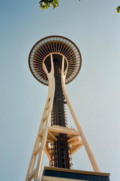 The Space Needle in Seattle is viewed from below against a clear sky.