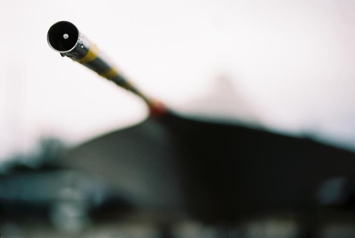 A pitot tube with yellow and black stripes is visible in the foreground, with a blurred aircraft in the background.