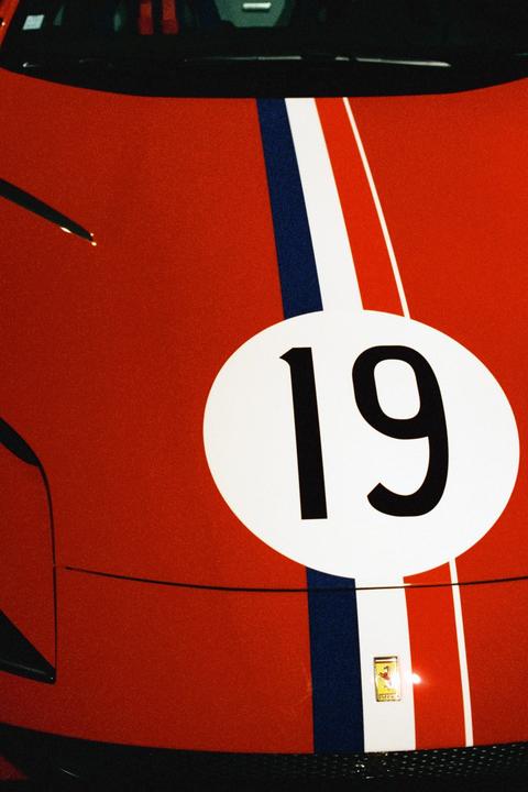 A red vehicle with a white racing stripe and the number 19 is visible.