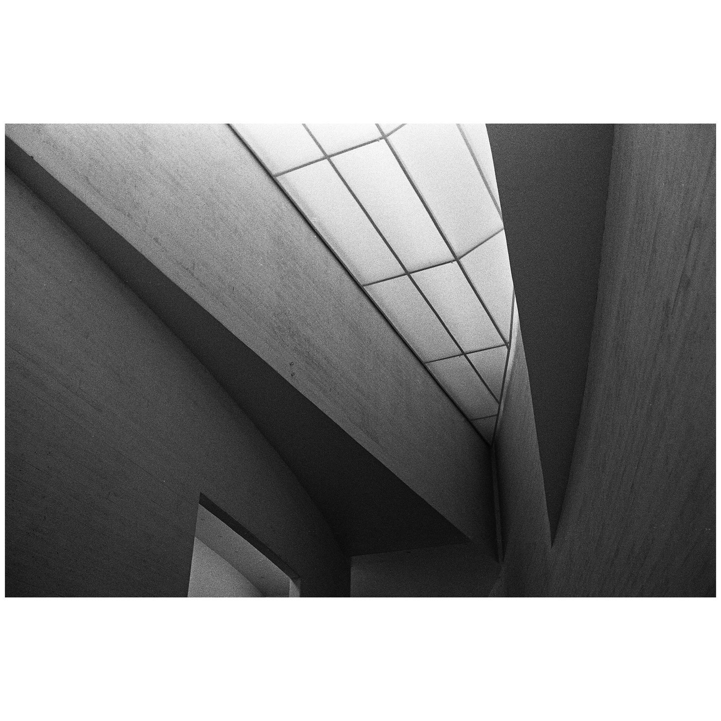 A low-angle view shows the geometric architecture of the Kiasma Art Museum with a grid-patterned ceiling.
