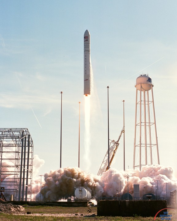 A rocket launches into the sky, leaving a trail of smoke and fire below it.
