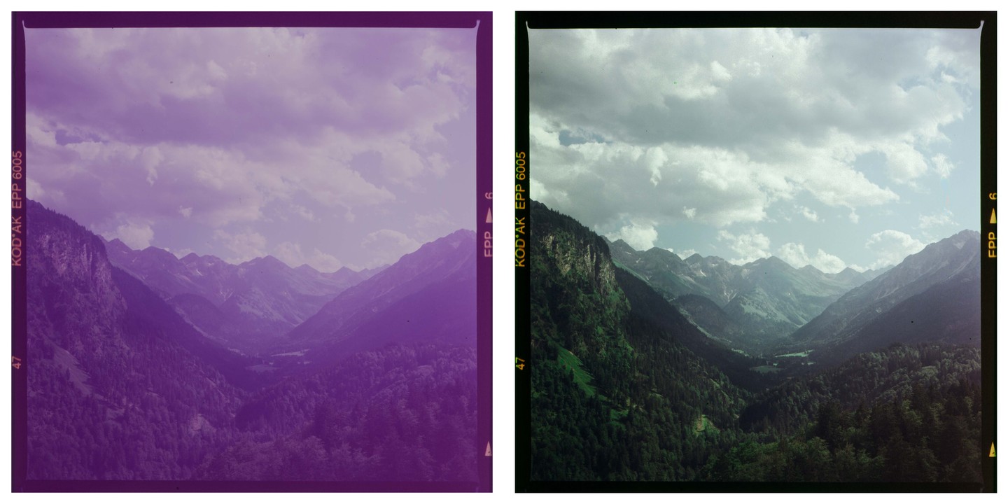 A valley with mountains and forests is visible under a cloudy sky.
