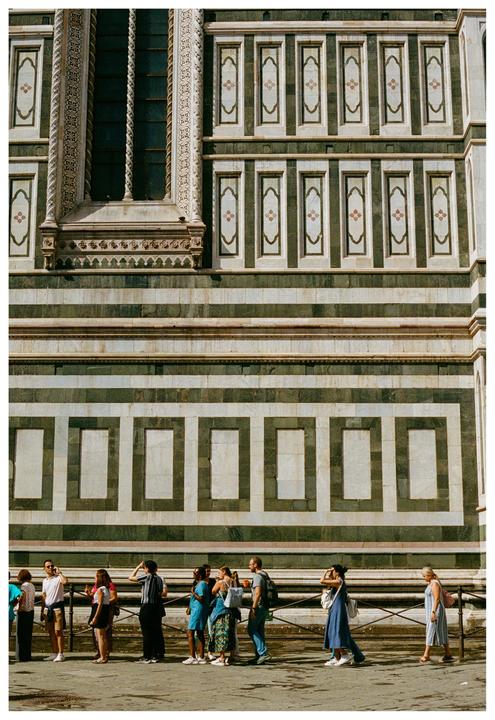 A group of people stands in front of the Florence Cathedral.
