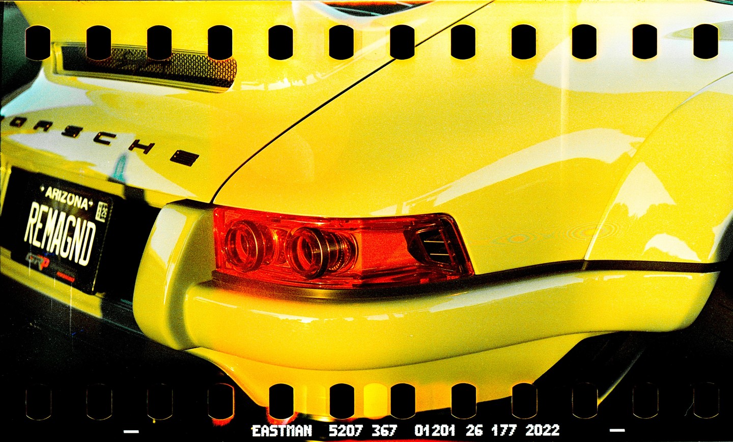 The rear of a yellow Porsche with an Arizona license plate is visible.