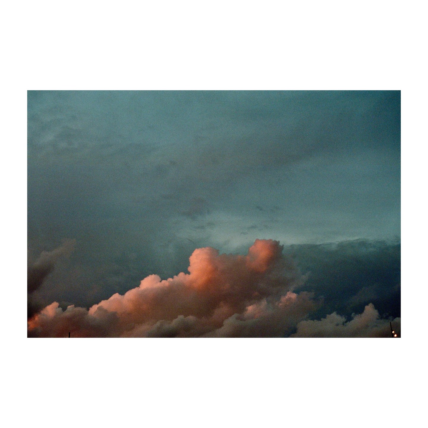Pink clouds are visible against a dark blue sky.