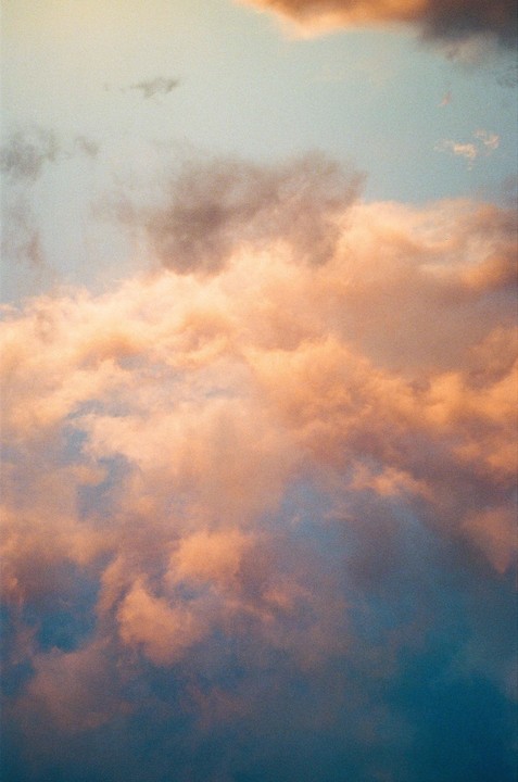 The sky is filled with clouds illuminated by the setting sun.
